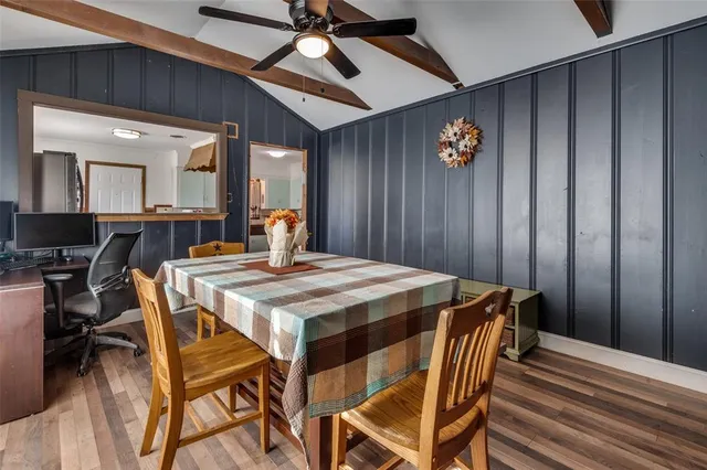 a dining room with a wooden table and chairs