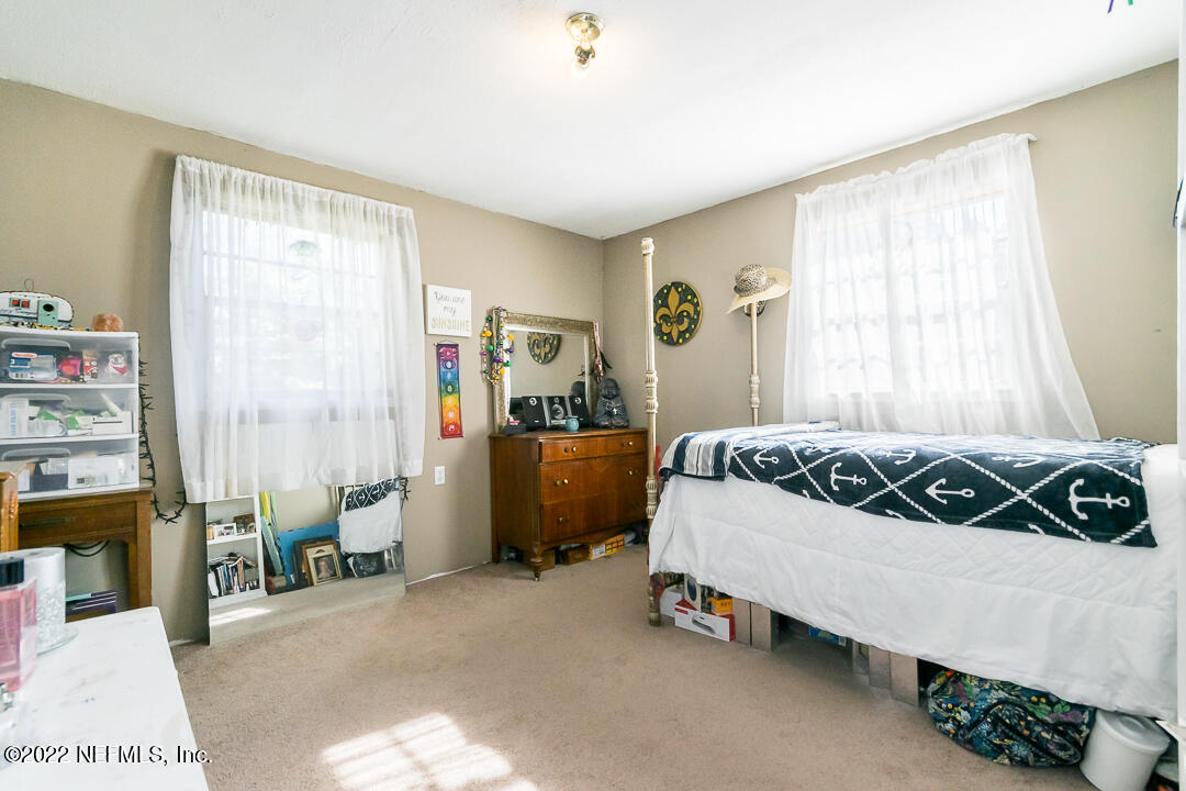 635 Jasmine Street Atlantic Beach, FL 32233 - Photo 14 of 20 a bedroom with a bed and a window