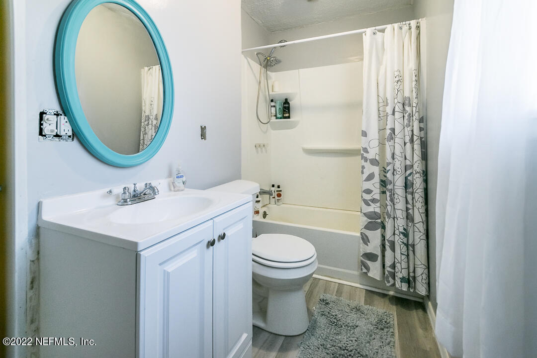 635 Jasmine Street Atlantic Beach, FL 32233 - Photo 16 of 20 a bathroom with a sink a toilet and a mirror