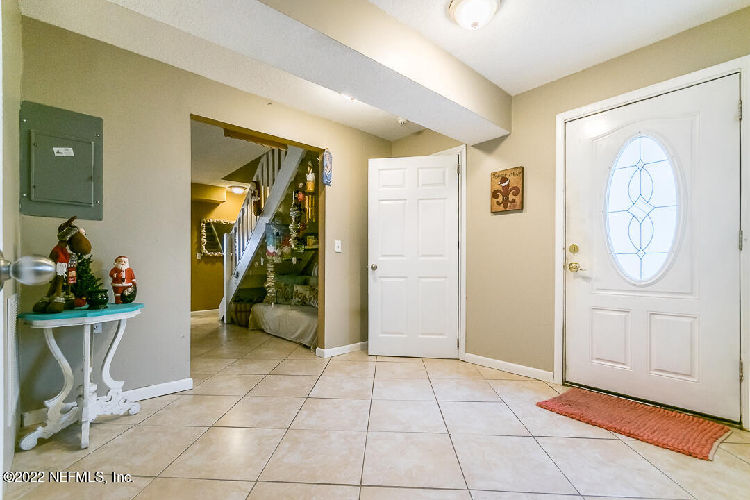 635 Jasmine Street Atlantic Beach, FL 32233 - Photo 4 of 20 a view of a livingroom with wooden floor and a bathroom