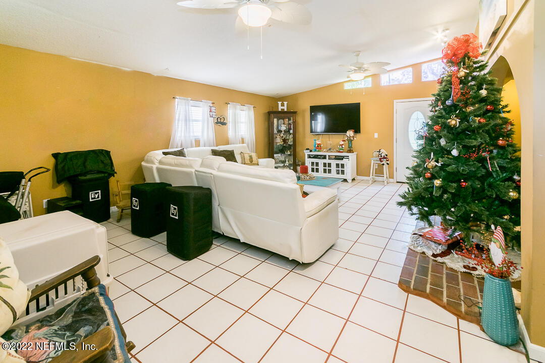 635 Jasmine Street Atlantic Beach, FL 32233 - Photo 6 of 20 a living room with furniture a flat screen tv and a potted plant