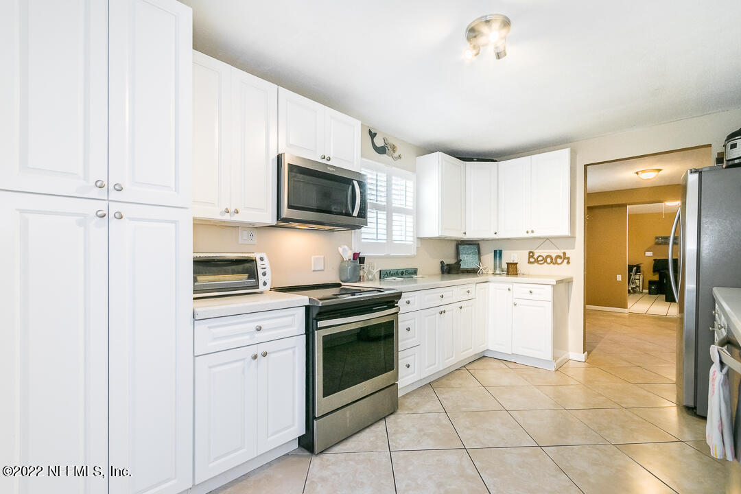 635 Jasmine Street Atlantic Beach, FL 32233 - Photo 9 of 20 a kitchen with cabinets stainless steel appliances and a counter top space