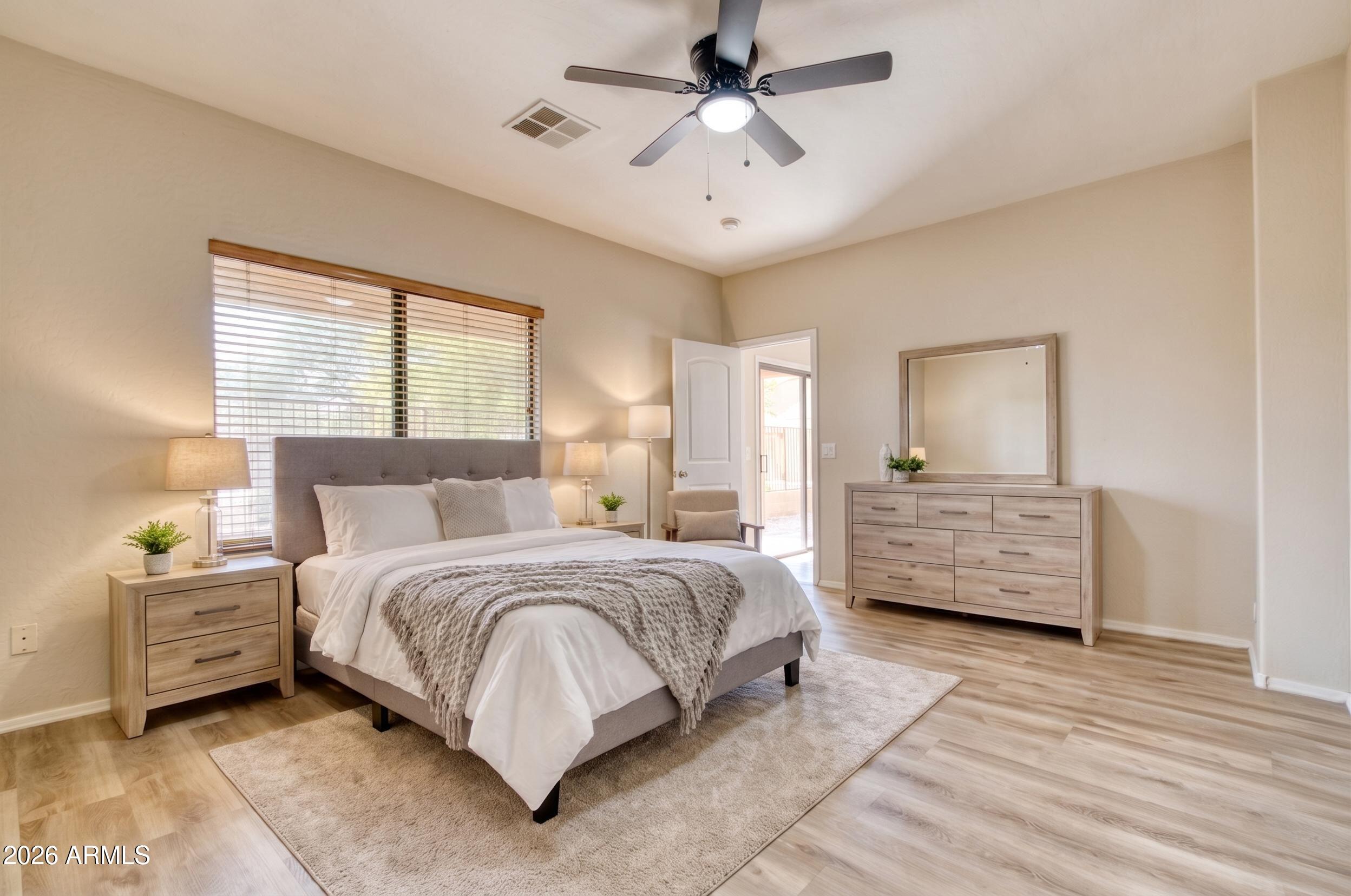 2565 South Signal Butte Road, Unit 46 Mesa, AZ 85209 - Photo 21 of 44 a bedroom with a bed a dresser and a window