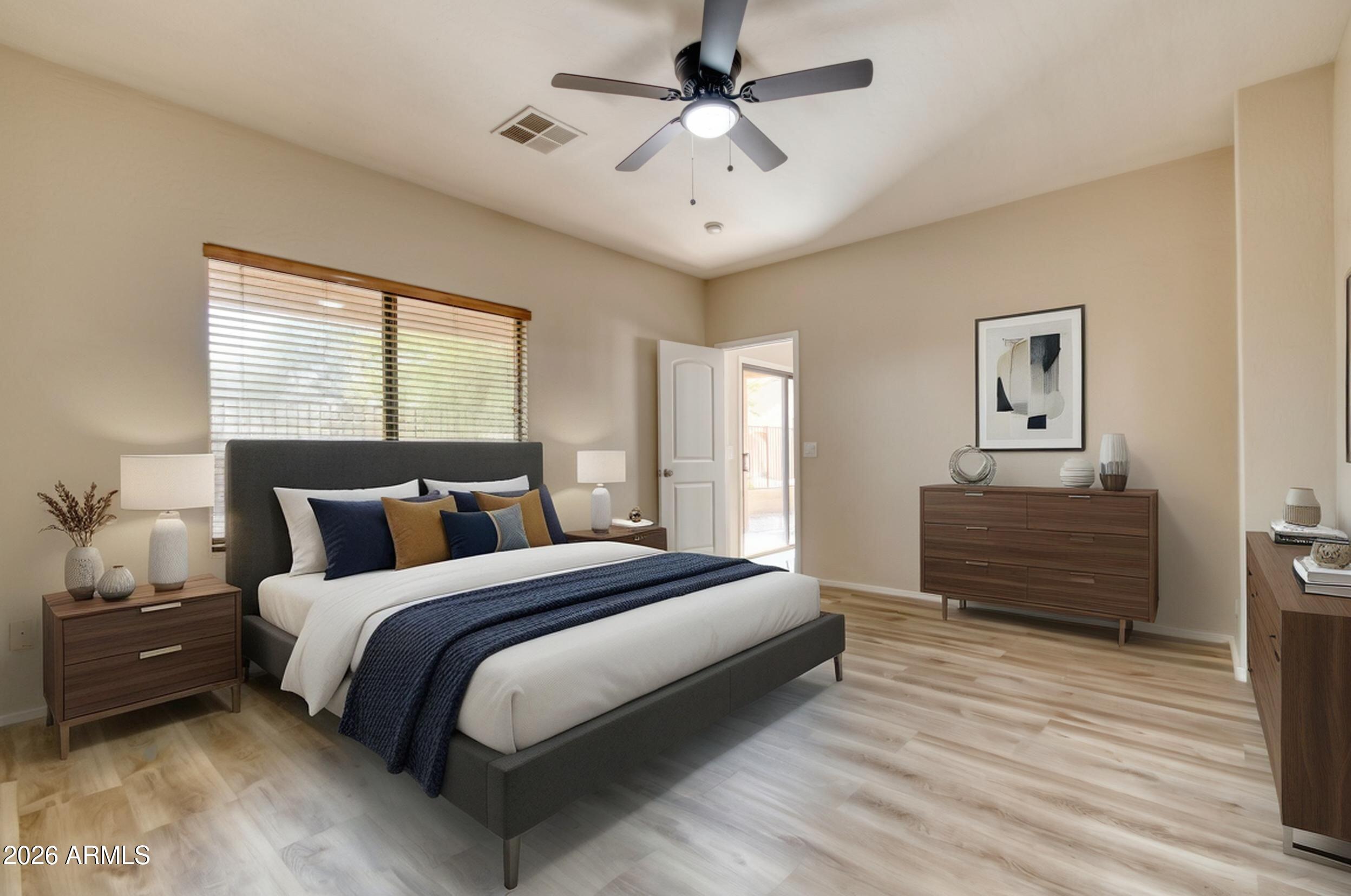 2565 South Signal Butte Road, Unit 46 Mesa, AZ 85209 - Photo 25 of 44 a bedroom with a bed and wooden floor