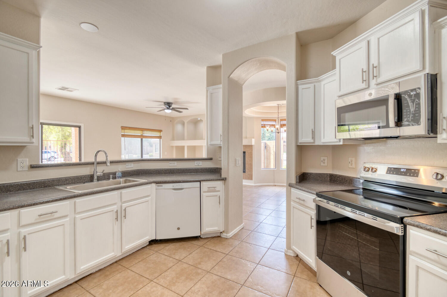 2565 South Signal Butte Road, Unit 46 Mesa, AZ 85209 - Photo 33 of 44 a kitchen with stainless steel appliances granite countertop a stove sink and cabinets