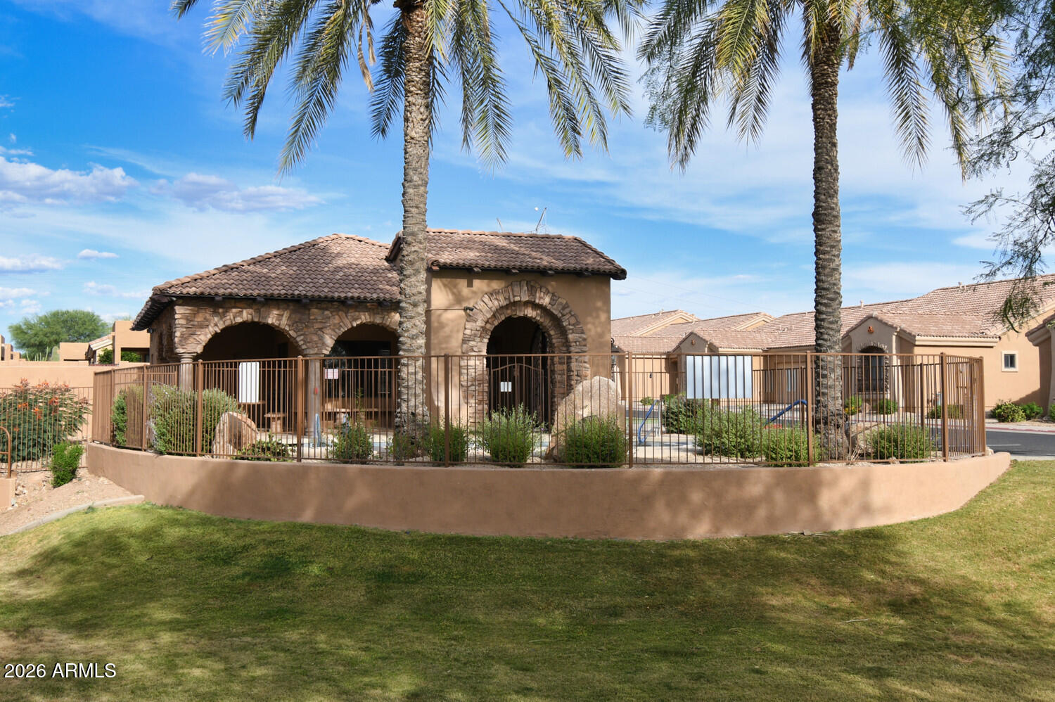 2565 South Signal Butte Road, Unit 46 Mesa, AZ 85209 - Photo 3 of 44 a front view of a house with a garden and yard