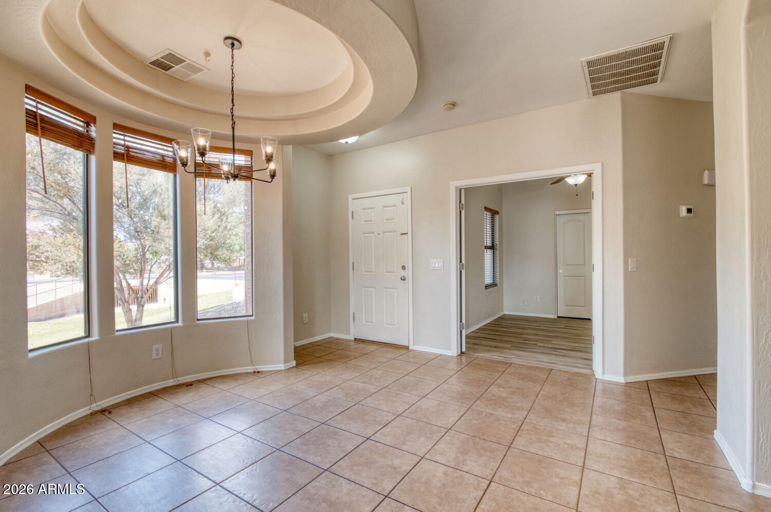 2565 South Signal Butte Road, Unit 46 Mesa, AZ 85209 - Photo 40 of 44 a view of a livingroom with a chandelier fan and windows