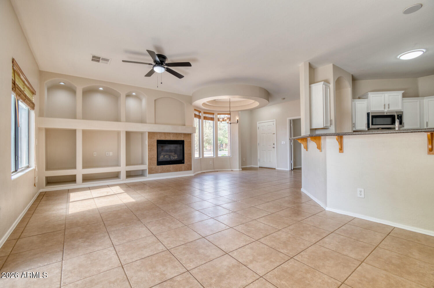 2565 South Signal Butte Road, Unit 46 Mesa, AZ 85209 - Photo 41 of 44 a view of an empty room with a fireplace and a window