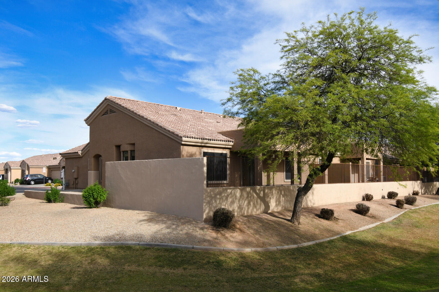 2565 South Signal Butte Road, Unit 46 Mesa, AZ 85209 - Photo 6 of 44 a view of a white house with a yard