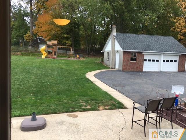 88 Dellwood Road Edison, NJ 08820 - Photo 15 of 16 a backyard of a house with table and chairs