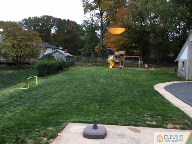 88 Dellwood Road Edison, NJ 08820 - Photo 16 of 16 a backyard of a house with table and chairs