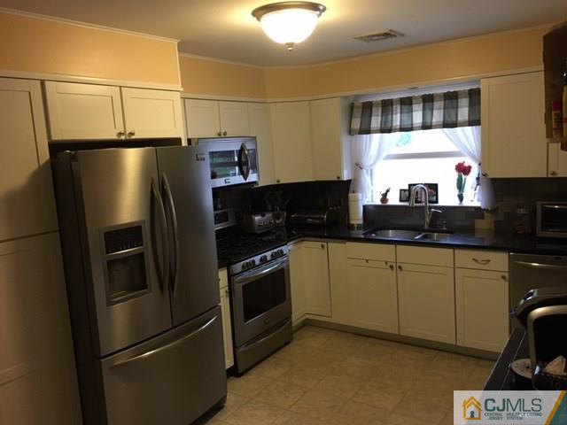 88 Dellwood Road Edison, NJ 08820 - Photo 4 of 16 a kitchen with stainless steel appliances a refrigerator sink and cabinets