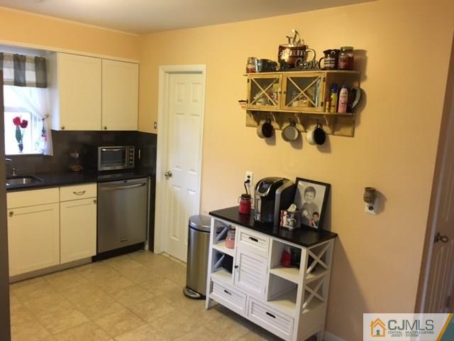 88 Dellwood Road Edison, NJ 08820 - Photo 5 of 16 a view of a kitchen with fridge and wooden floor