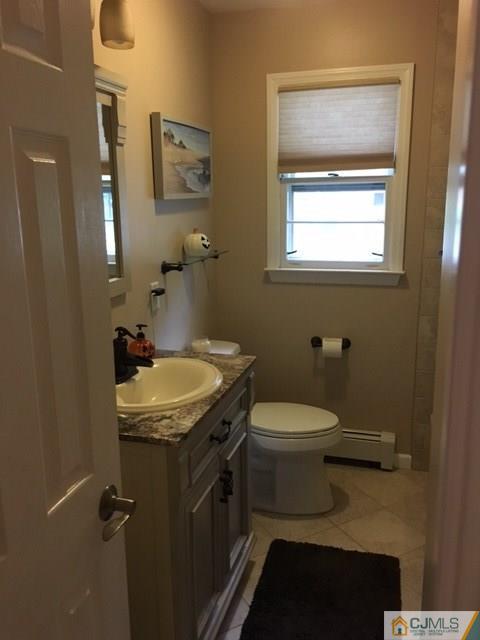 88 Dellwood Road Edison, NJ 08820 - Photo 9 of 16 a bathroom with a granite countertop toilet sink and mirror