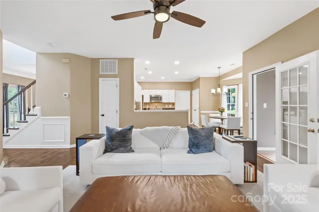 a living room with furniture and a view of kitchen