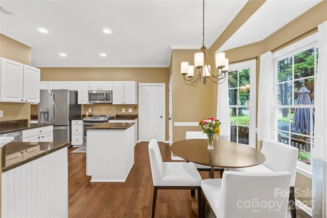 a kitchen with kitchen island a dining table and appliances
