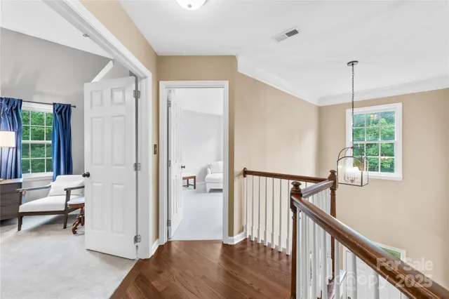 a view of a bedroom with furniture and windows