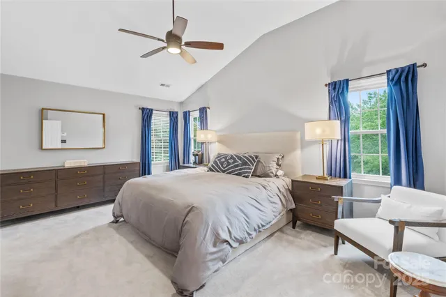 a bedroom with a large bed and a window