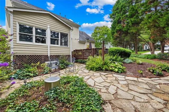 a view of a chair and table in the garden