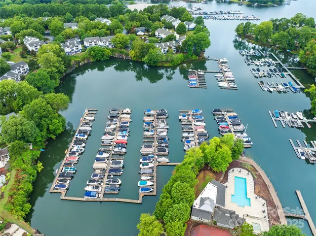an aerial view of a residential apartment building with a yard and plants