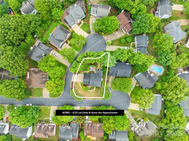 an aerial view of residential house with outdoor space and swimming pool