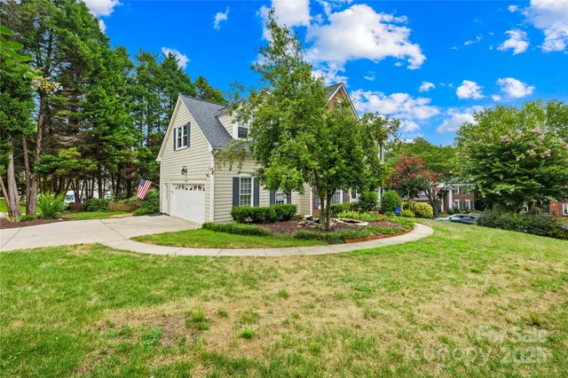 a view of a house with a yard and tree s