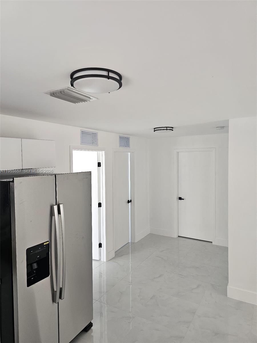 11997 Southwest 218th Street Miami, FL 33170 - Photo 11 of 16 a view of a kitchen with a refrigerator and microwave