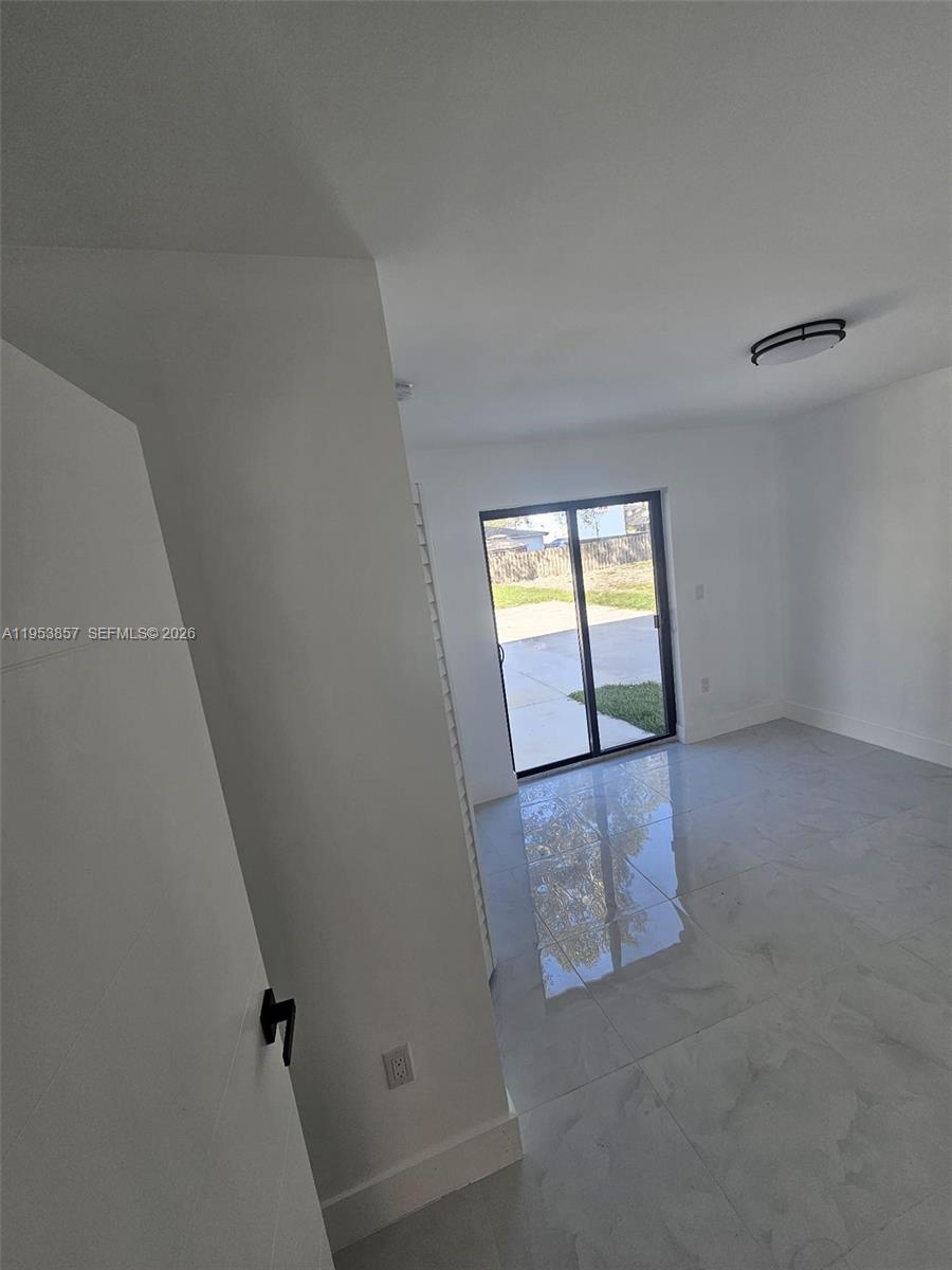 11997 Southwest 218th Street Miami, FL 33170 - Photo 13 of 16 a view of an empty room and window