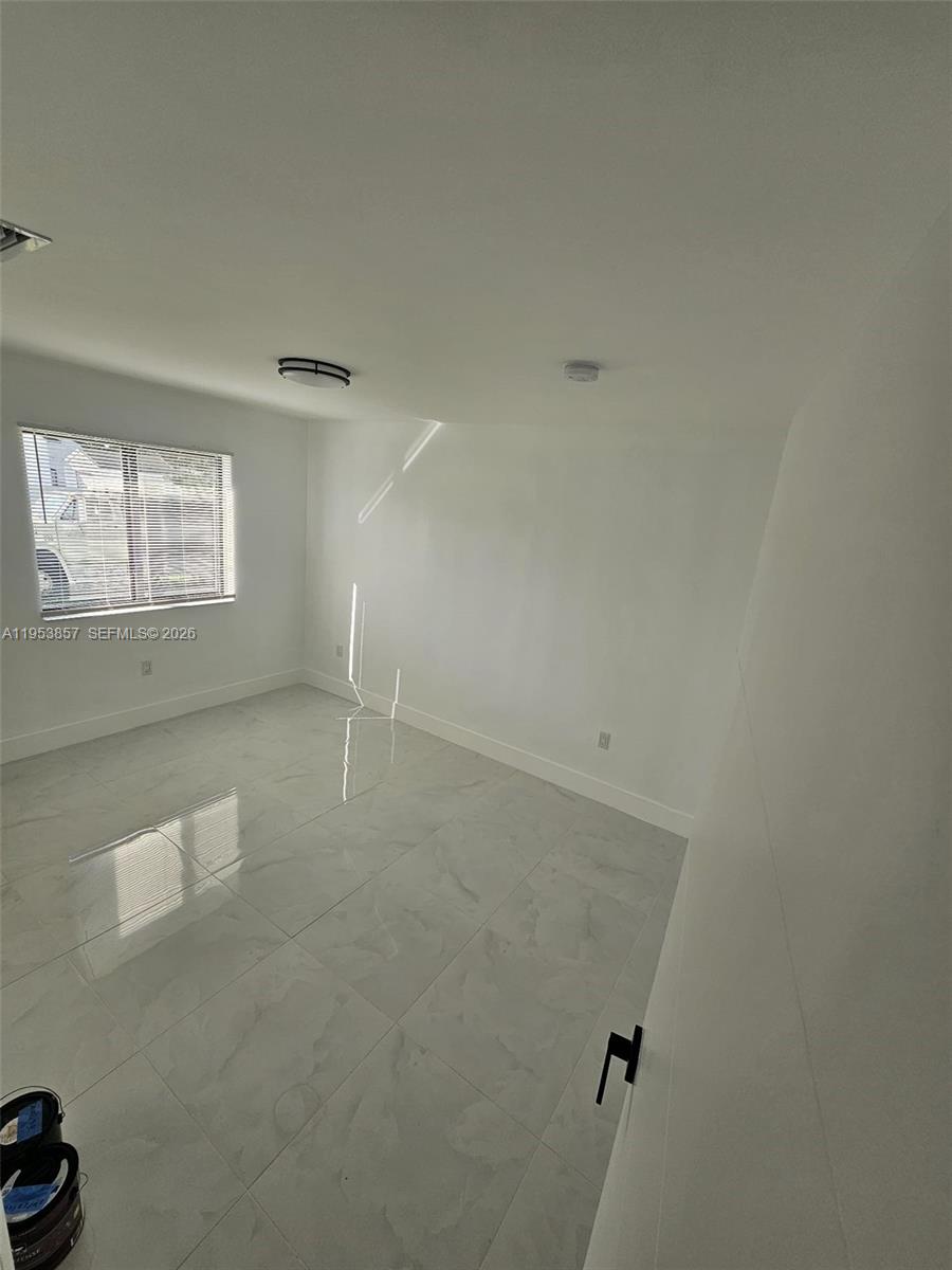 11997 Southwest 218th Street Miami, FL 33170 - Photo 14 of 16 an empty room with windows