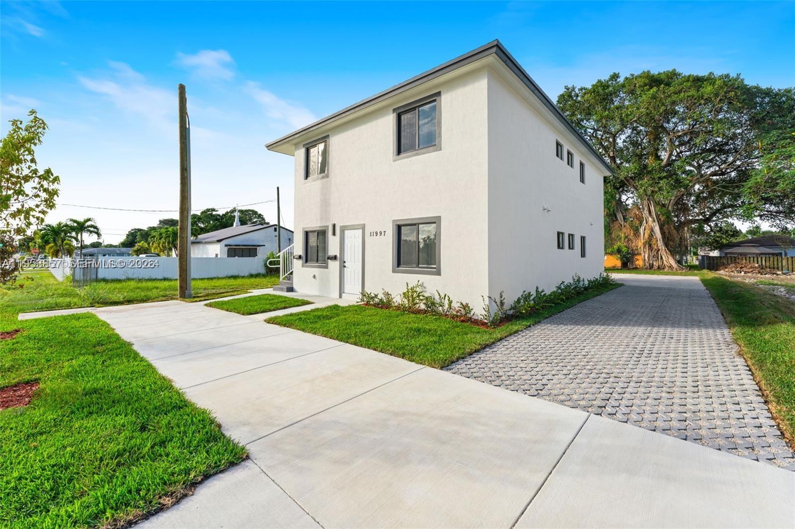 11997 Southwest 218th Street Miami, FL 33170 - Photo 15 of 16 a view of a white house with a yard