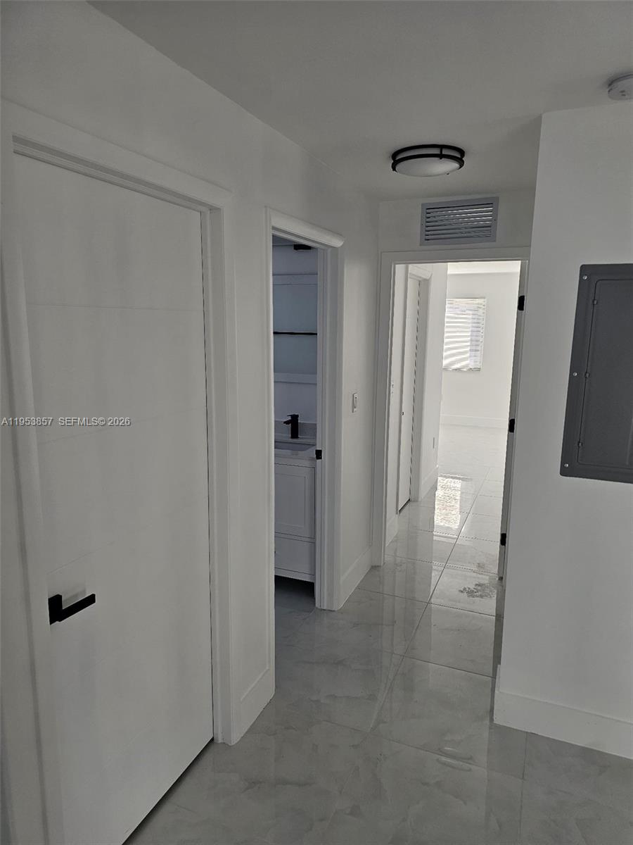 11997 Southwest 218th Street Miami, FL 33170 - Photo 4 of 16 a view of a hallway with wooden floor