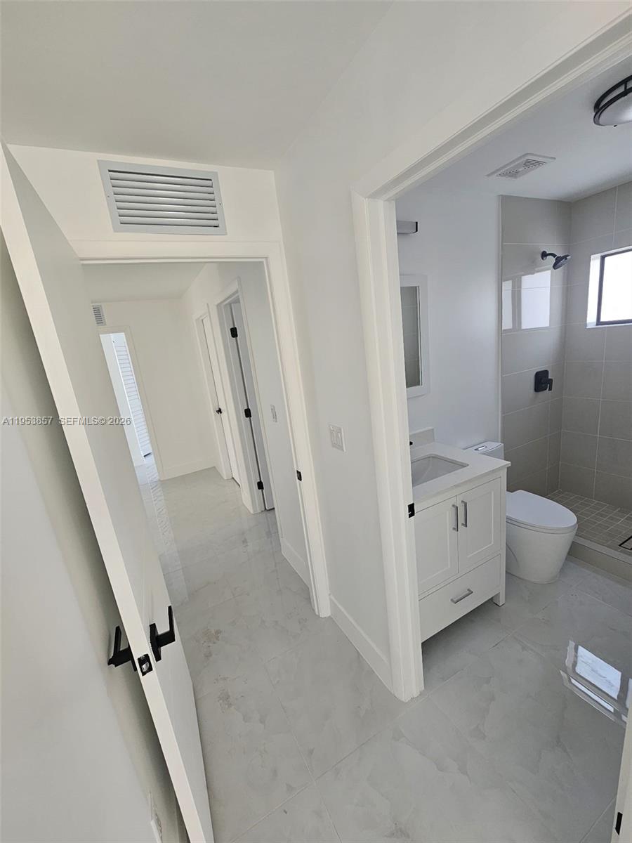 11997 Southwest 218th Street Miami, FL 33170 - Photo 7 of 16 wooden floor with white walls