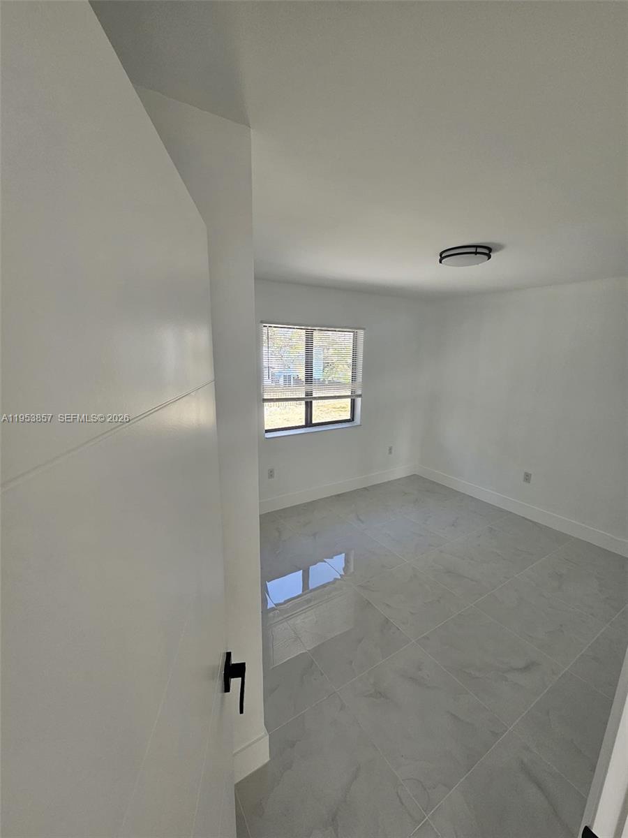 11997 Southwest 218th Street Miami, FL 33170 - Photo 8 of 16 a view of an empty room and window