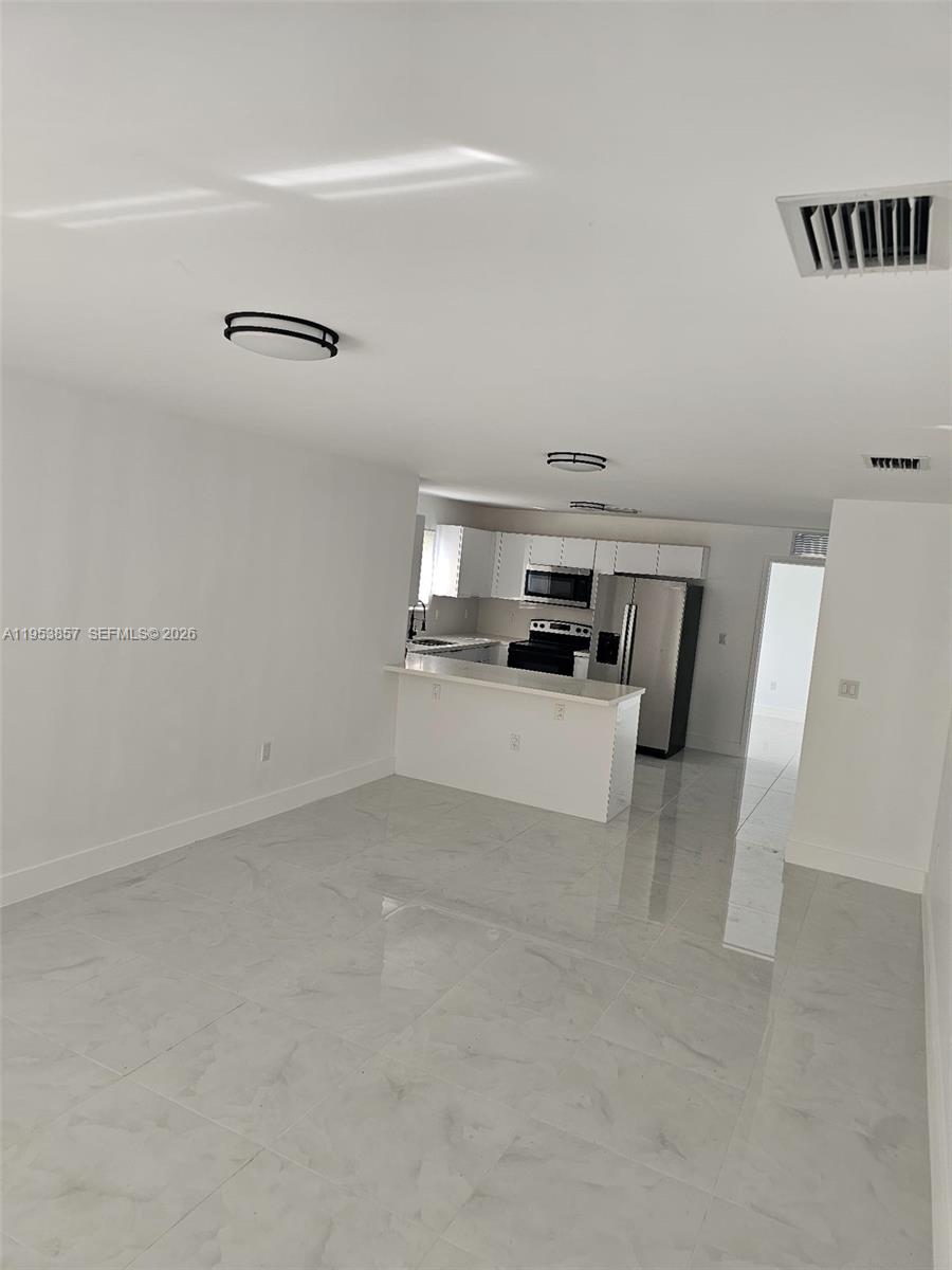 11997 Southwest 218th Street Miami, FL 33170 - Photo 10 of 16 a view of kitchen and refrigerator