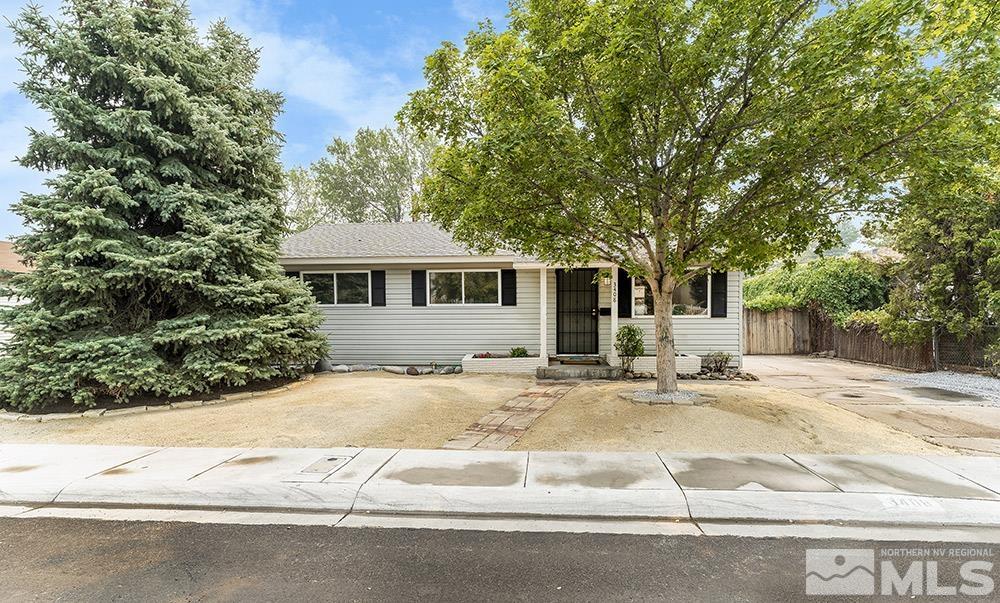 3408 Rauscher Drive Reno, NV 89503 - Photo 1 of 16 a front view of a house with yard and trees in the background