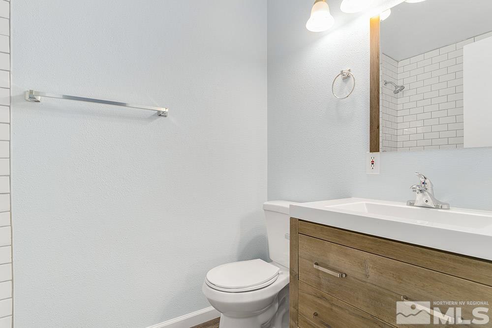 3408 Rauscher Drive Reno, NV 89503 - Photo 9 of 16 a bathroom with a sink a toilet and a mirror
