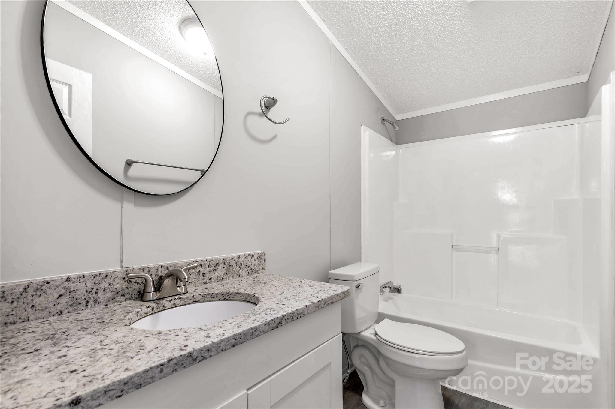 2007 Sugar Hill Road York, SC 29745 - Photo 20 of 36 a bathroom with a granite countertop sink toilet mirror and a shower