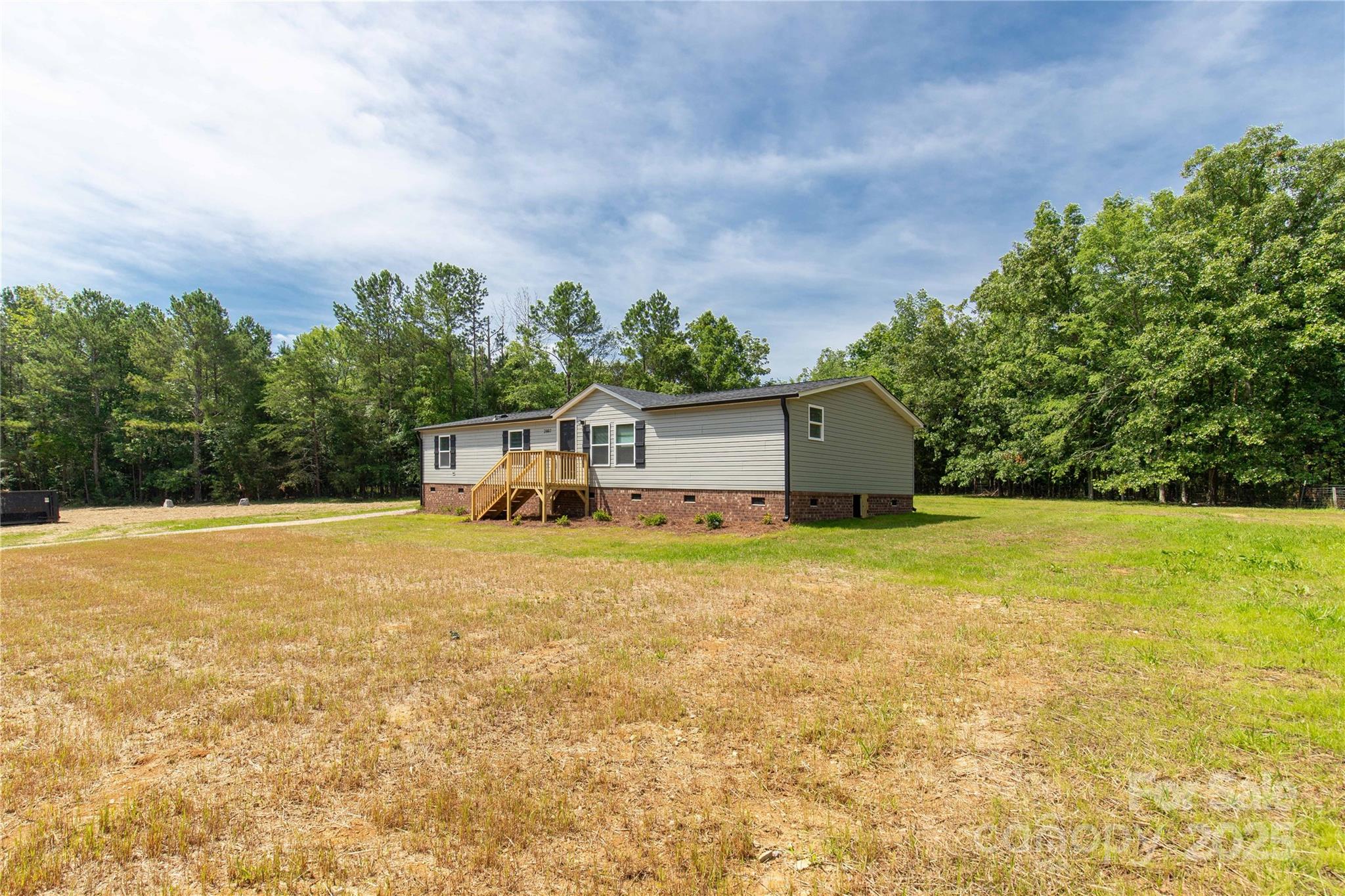 2007 Sugar Hill Road York, SC 29745 - Photo 3 of 36 a front view of house with yard and trees in the background