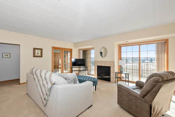 a living room with furniture fireplace and flat screen tv