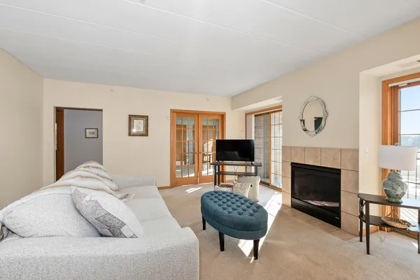 a living room with furniture a fireplace and a flat screen tv