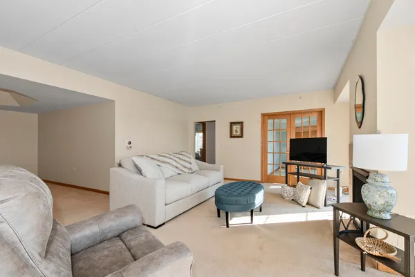 a living room with furniture a flat screen tv and a window