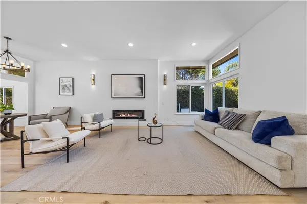 a living room with furniture and large windows
