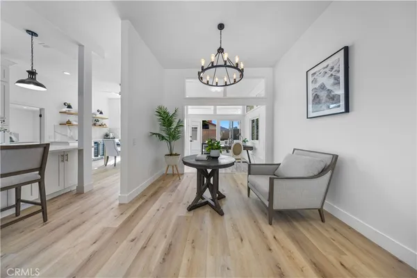 a view of a dining room with furniture wooden floor and a chandelier