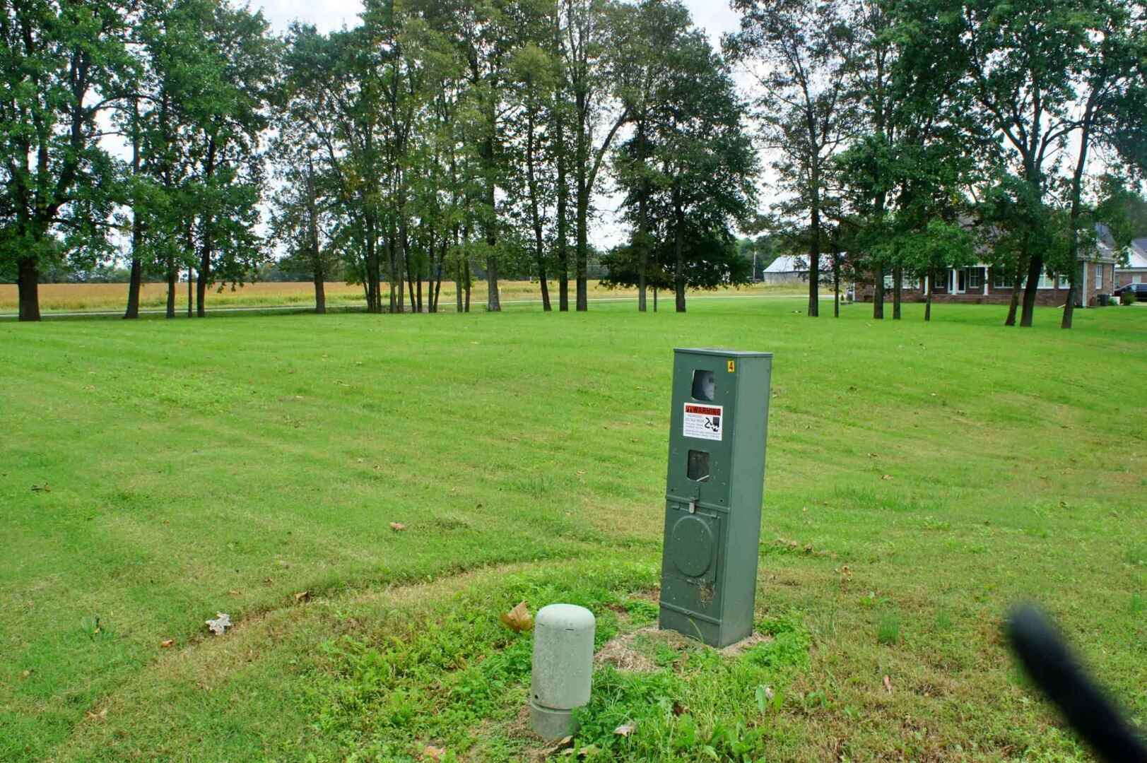 0 Hawthorne Lane Metropolis, IL 62960 - Photo 12 of 12 a sign board with grassy field and trees