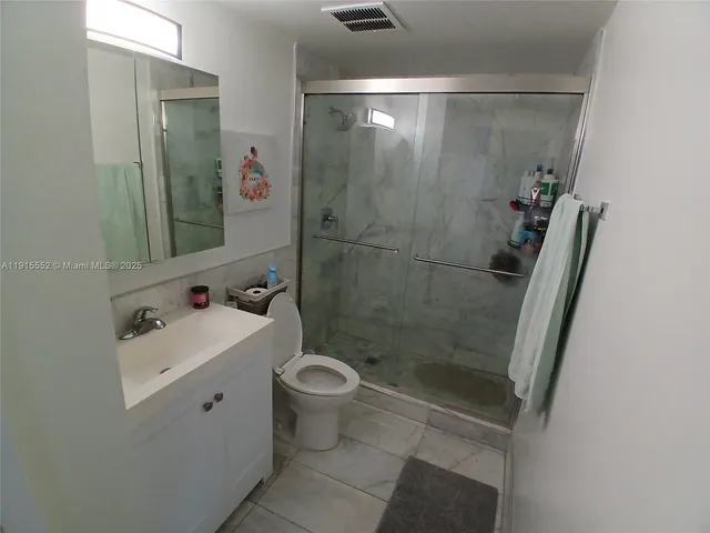 a bedroom with two beds and large window