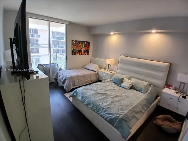 a bed room with furniture and a flat screen tv