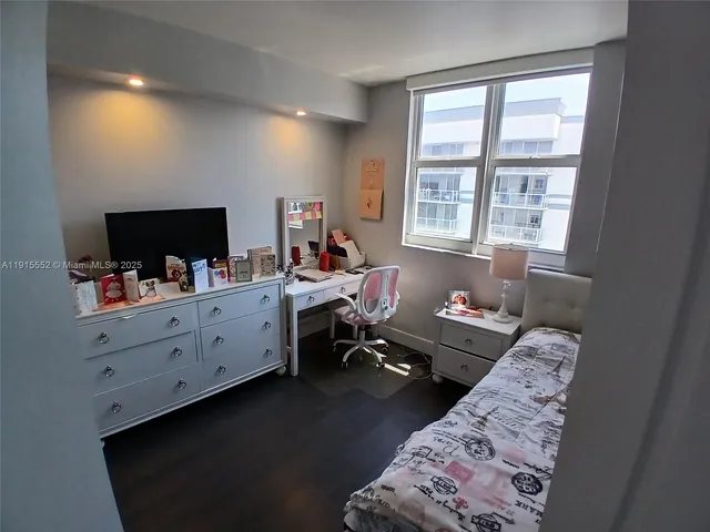 a view of a workspace with furniture and a flat screen tv