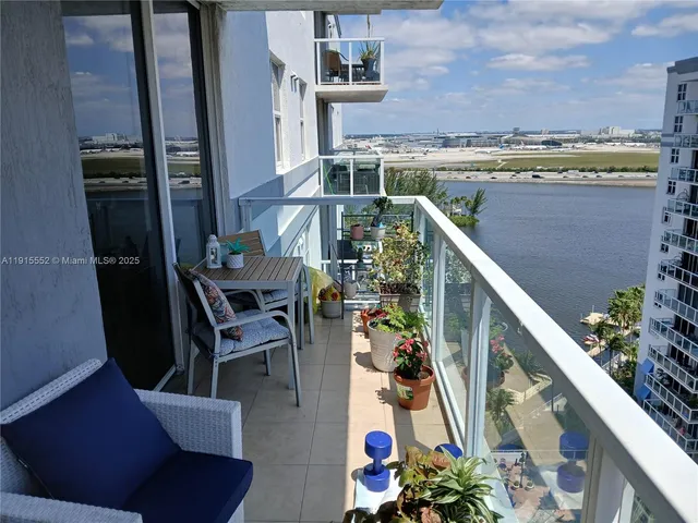 a balcony with table and chairs