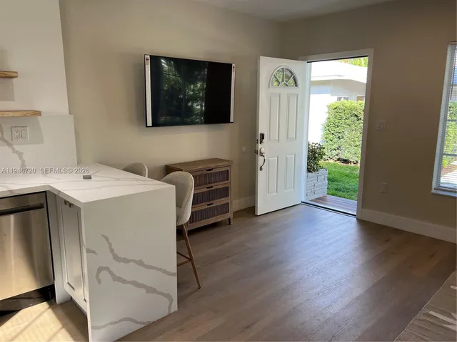 a view of a hallway with workspace and a window