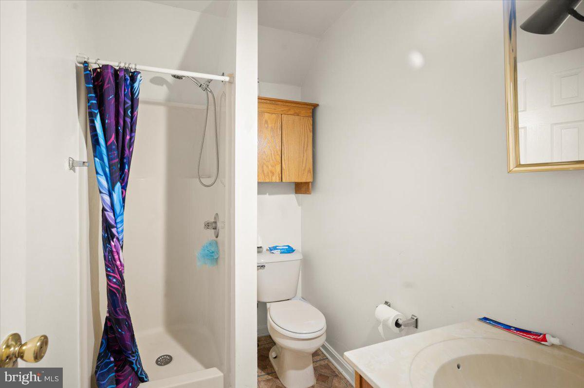 118 Ranson Estates Circle Ranson, WV 25438 - Photo 17 of 34 a white toilet sitting next to a bathroom sink and a shower